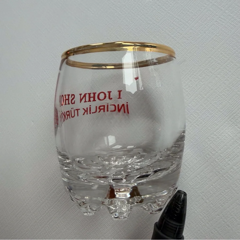 VTG I John Shop in‎ Incirlik, Türkiye shot glass in a gold rim & bold red text